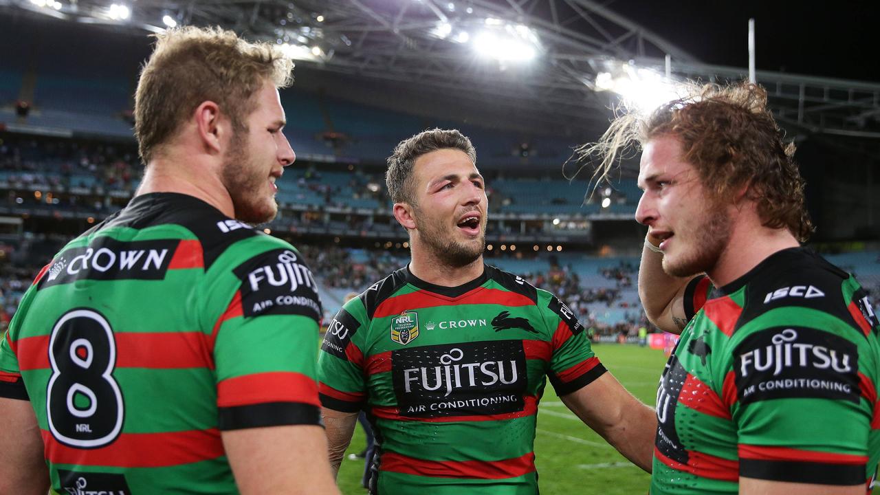 Tom with Sam and George after a finals victory. Picture: Brett Costello