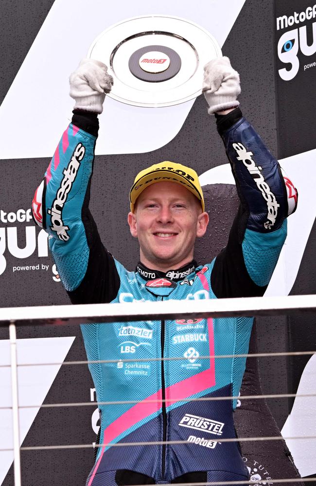 Third-placed CFMoto Racing Prustel's Australian rider Joel Kelso celebrates on the podium after competing in the Moto3 class race of the MotoGP Australian Grand Prix in Phillip Island on October 22, 2023. (Photo by William WEST / AFP)