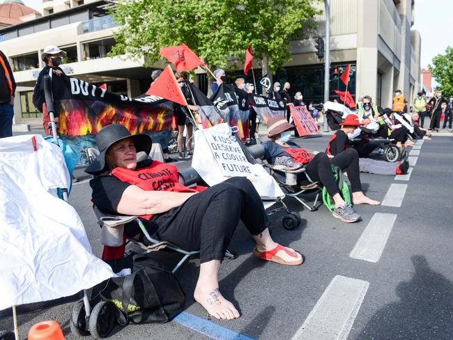 Extinction Rebellion protesters glued to King William St in Victoria Square. Picture: NCA NewsWire/Brenton Edwards