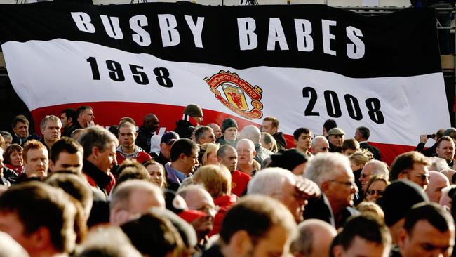 The public pay their respects during a memorial service at Old Trafford Stadium on the 50th anniversary of the Munich air disaster. (AP Photo/PA, Gareth Copley)