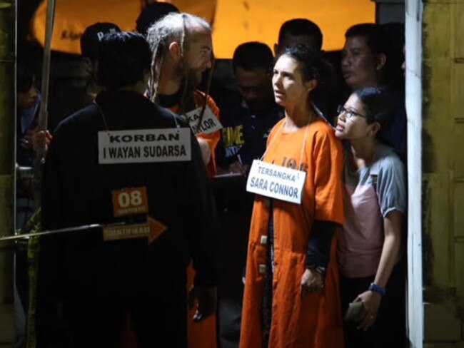 The couple looking frail as they are surrounded by police. Picture: Zul Edoardo.