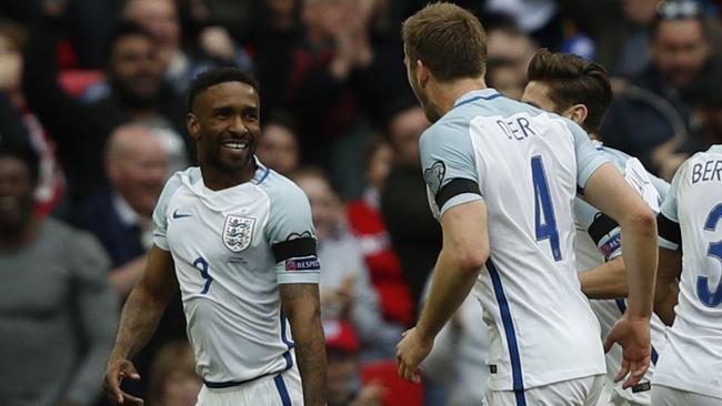 England's striker Jermain Defoe (L) celebrates with teammates after scoring.