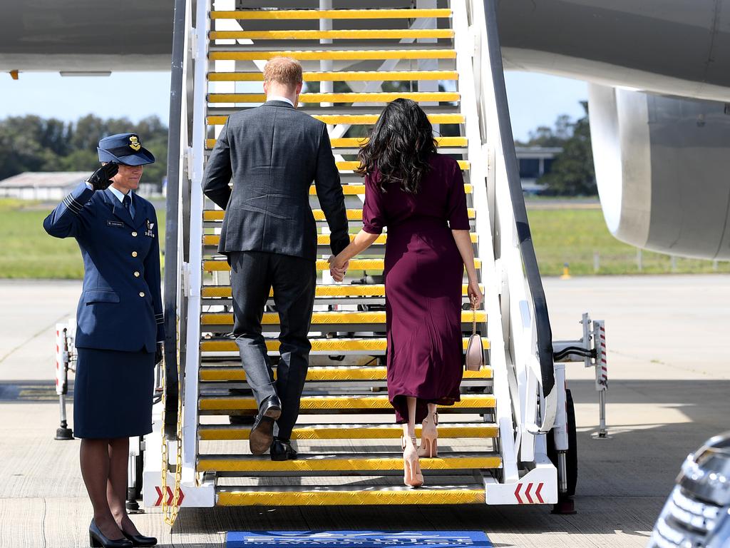 The royals boarded the plane holding hands. Picture: Joel Carrett