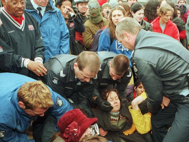 Police remove protesters to allow American basketball team official to enter the World Economic Forum (WEF) in Melbourne in September 2000. Picture: Craig Wood