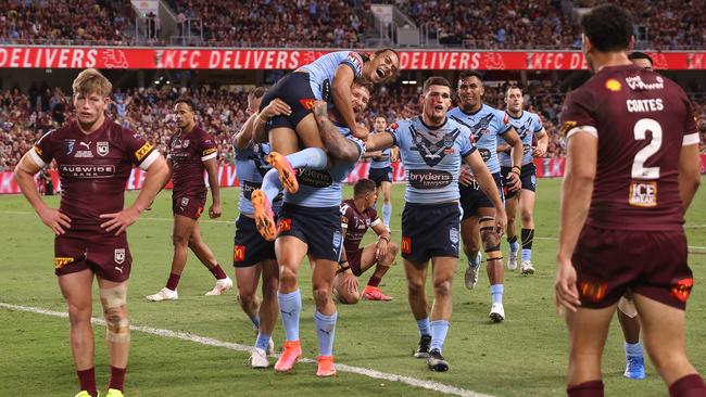 Jerome Luai is lifted by Tariq Sims of the Blues celebrate after a try in Townsville on Wednesday. Picture: Getty Images