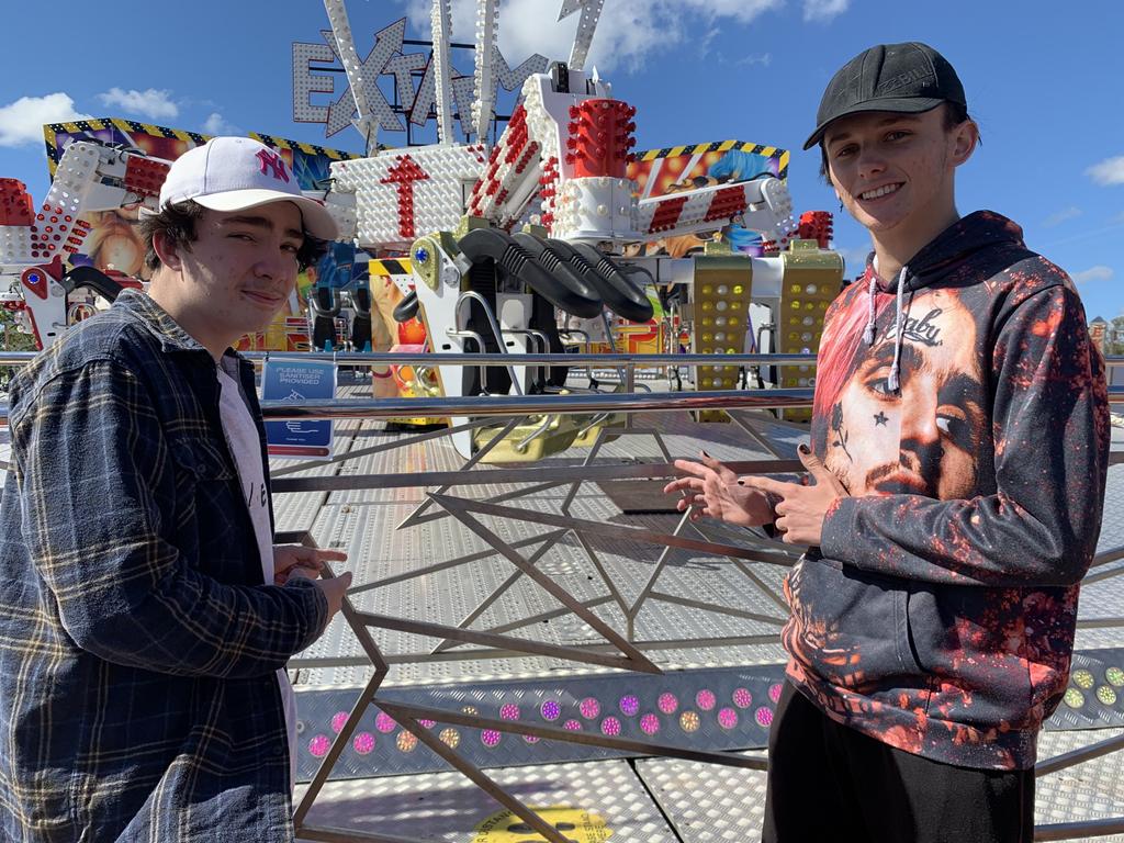 (L) Travis Wason and Jesse Barnell point to the Extreme ride they went on at the Fraser Coast Ag Show.