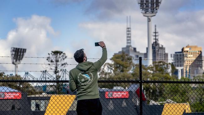 A man takes pictures of Richmond’s empty headquarters at Punt Rd Oval on Sunday morning. Picture: NCA NewsWire/David Geraghty