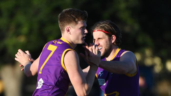 Sam Higgins (Left) of the Old Collegians is congratulated by team mate Lindsay Apted during the VAFA Premier match at Brighton Beach Oval, Melbourne, Saturday, Jane 2, 2018. Old Brighton v Old Collegians. (AAP Image/James Ross) NO ARCHIVING