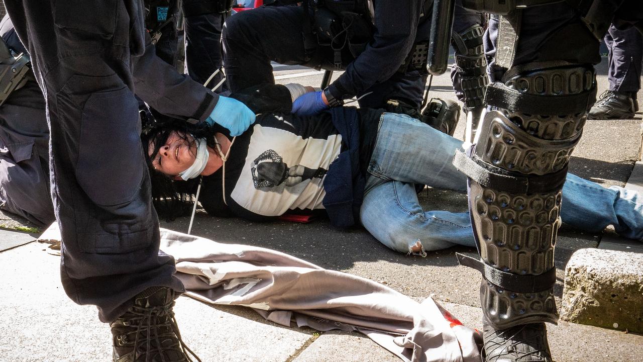 A woman is detained by members of Victoria Police. Picture: Darrian Traynor/Getty Images