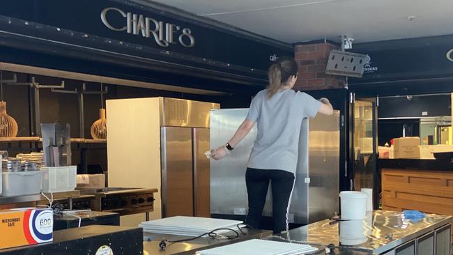 Staff at Charlie’s Restaurant Cafe and Bar in Surfers Paradise moving furniture in the business on Thursday afternoon.