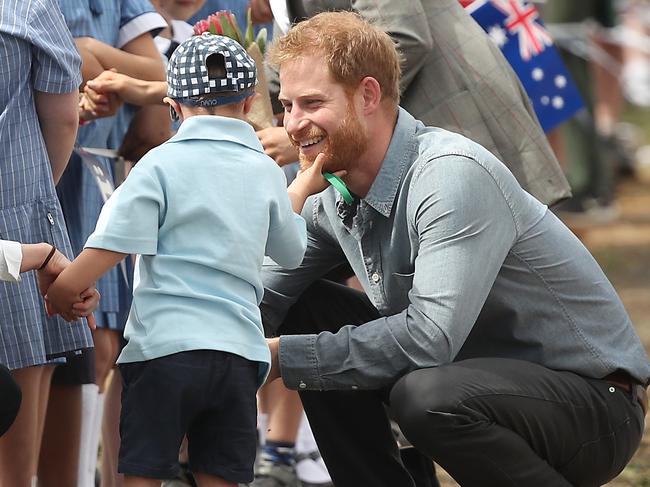 Luke Vincent, 5, grabs Prince Harry’s beard during their visit in Dubbo. Picture: Getty