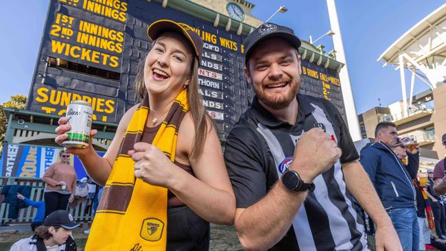 Hawk Fan Danielle Bowden and Pies fan Daniel Down under The Adelaide Oval Scoreboard at the Hawks and Collingwood clash. Picture: Ben Clark