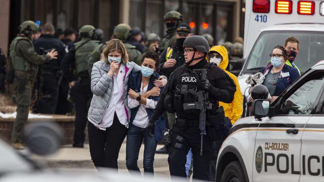 Women are assisted from King Soopers grocery store by police after a mass shooting on Monday. Picture: Chet Strange/Getty Images/AFP