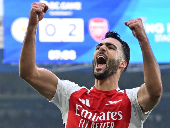 TOPSHOT - Arsenal's Spanish midfielder #23 Mikel Merino celebrates after scoring their second goal during the English Premier League football match between Leicester City and Arsenal at King Power Stadium in Leicester, central England on February 15, 2025. (Photo by JUSTIN TALLIS / AFP) / RESTRICTED TO EDITORIAL USE. No use with unauthorized audio, video, data, fixture lists, club/league logos or 'live' services. Online in-match use limited to 120 images. An additional 40 images may be used in extra time. No video emulation. Social media in-match use limited to 120 images. An additional 40 images may be used in extra time. No use in betting publications, games or single club/league/player publications. /