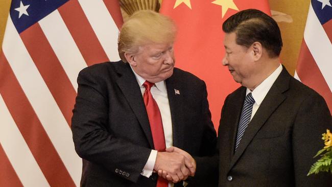 (FILES) In this file photo taken on November 09, 2017, US President Donald Trump (L) shakes hand with China's President Xi Jinping at the end of a press conference at the Great Hall of the People in Beijing. - China said Monday, May 13, 2019 it will raise tariffs on $60 billion worth of US goods from June 1, in retaliation to the latest round of US tariff hikes and Washington's plans to target almost all Chinese imports. The announcement came after the latest round of US-China trade negotiations ended Friday, May 10, 2019 without a deal, and after Washington increased tariffs on $200 billion worth of Chinese goods. (Photo by Fred DUFOUR / AFP)