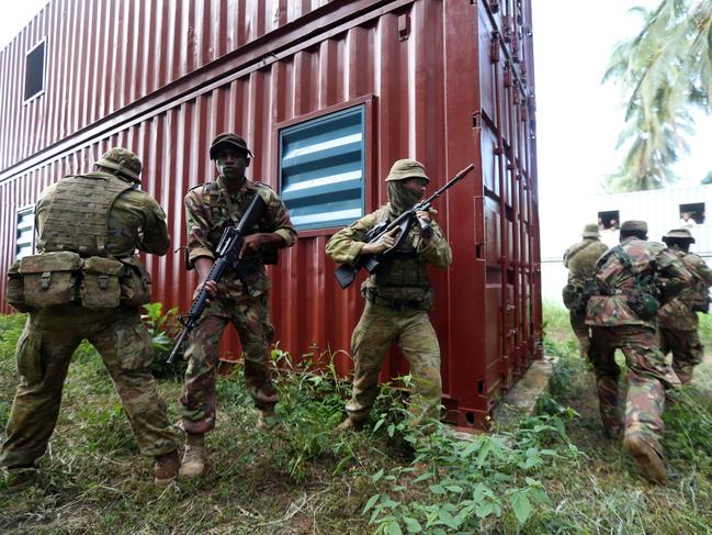 Aussie diggers with PNG soldiers during an exercise in urban warfare. Picture Gary Ramage