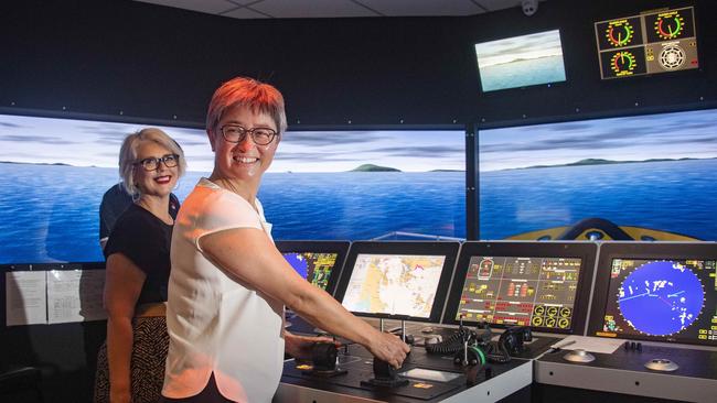 Labor foreign affairs spokeswoman Penny Wong takes the controls of a ship simulator during a visit to Cairns alongside Elida Faith. Picture: Brian Cassey