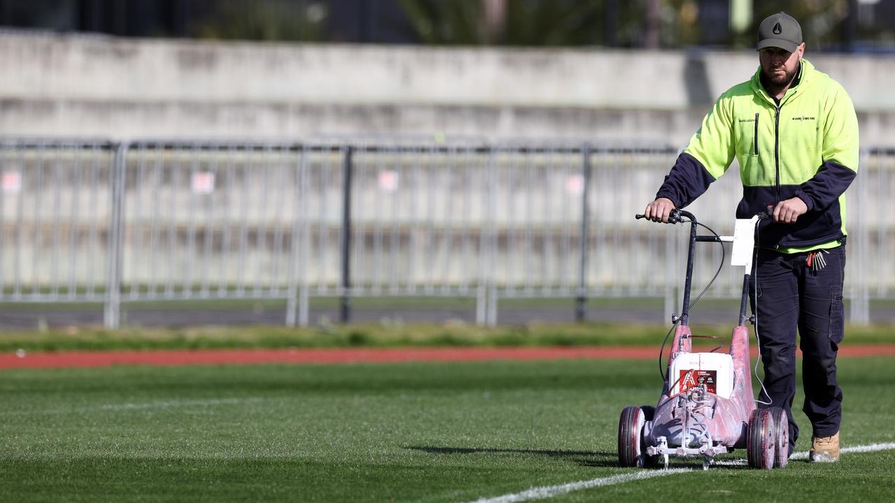 A groundsman painting a new boundary line to emulate the smaller SCG at Olympic Park. Picture: Michael Klein