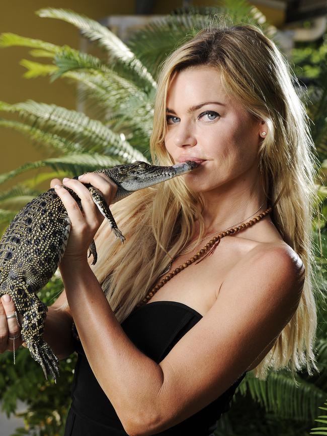 2015: Sophie Monk gives Fluffy the baby saltwater crocodile a kiss at Crocosaurus Cove in Darwin. Picture: Aaron Burton