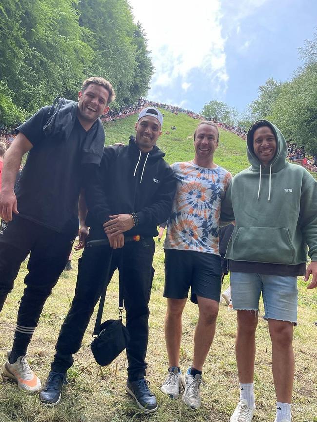 James Maloney (2R) takes part in the Cooper’s Hill cheese rolling event.