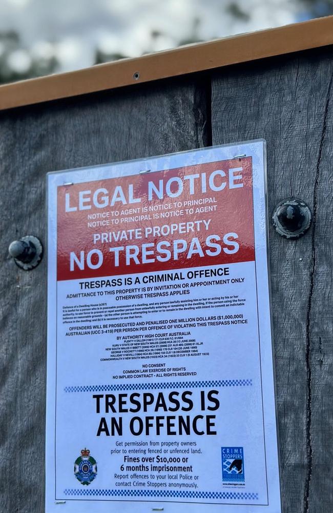 Residents are putting these signs up on fences in Samford to deter biosecurity officers from coming on to their properties to lay down bait. Picture: Sarah McGuire