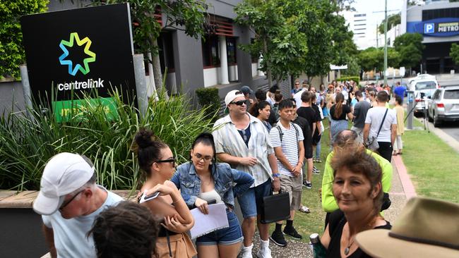 People are seen queuing outside the Centrelink office in Southport on the Gold Coast in March as the pandemic hit Australia. Picture: AP/Dan Peled