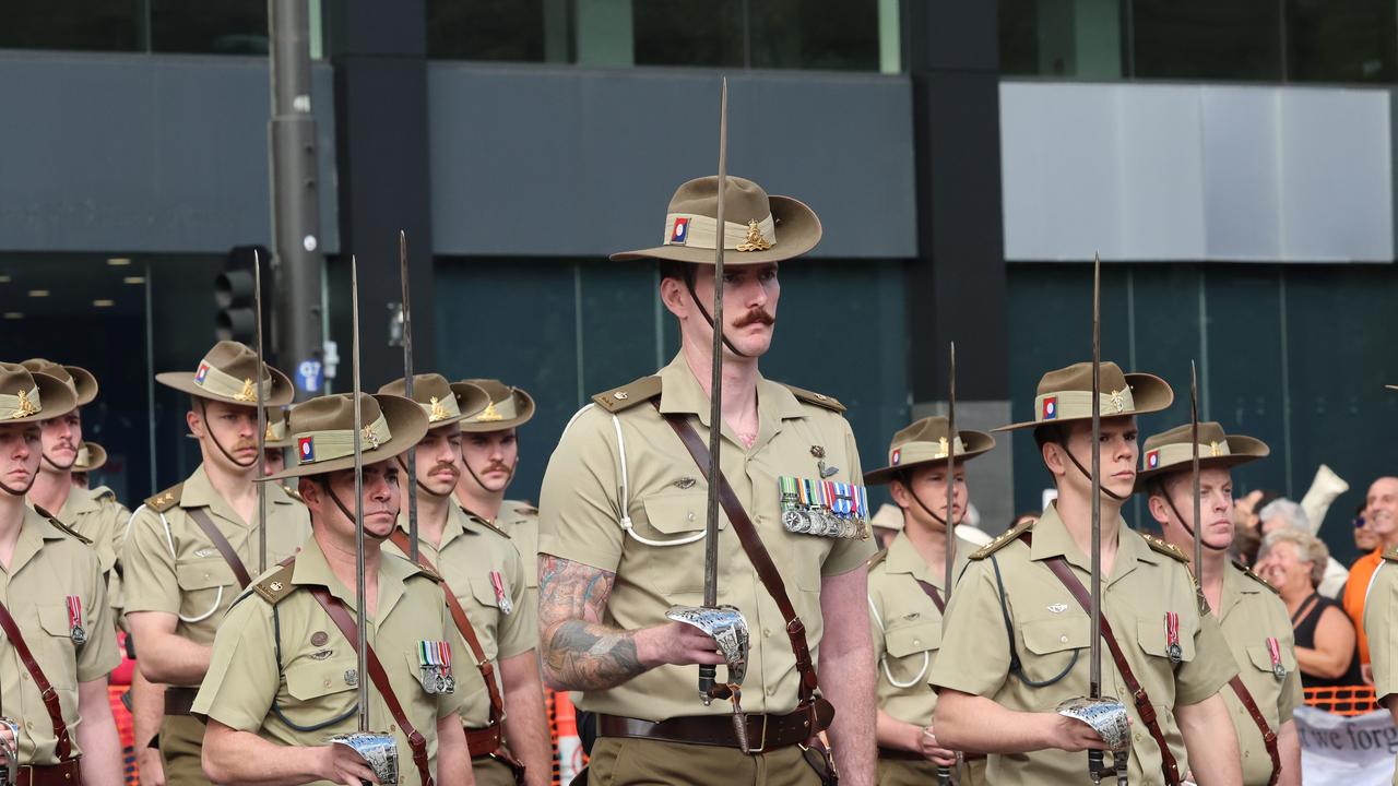 Major Andrew Evans honoured his late friend Capt Paul McKay by carrying his sword in the Anzac Day march. Picture: Russell Millard