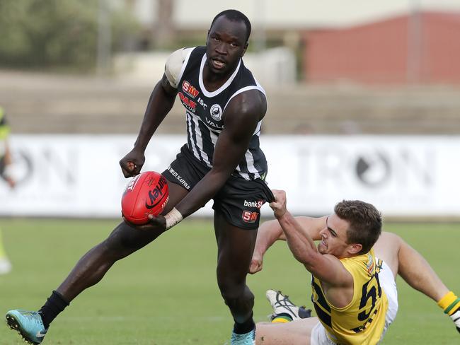 14/04/18 - SANFL - Port Adelaide v Eagles at Alberton Oval. Irra Emmanuel gets his handpass away from Jake Westbrook. Picture SARAH REED