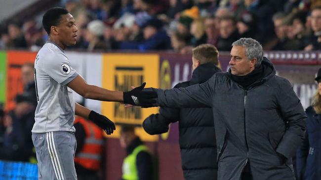 Goal-scorer Manchester United's French striker Anthony Martial (L) shakes hands with Manchester United's Portuguese manager Jose Mourinho