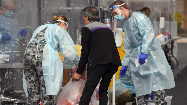 Members of the Australian Defence Force package swab samples ready for testing at a drive-through COVID-19 coronavirus testing station in Melbourne. Picture: AFP