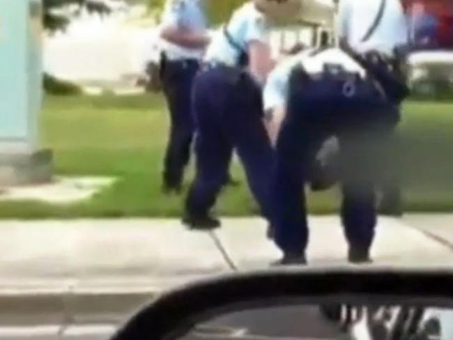 Distraught ... An officer drops to his knees after the woman is shot. Picture: Channel 9