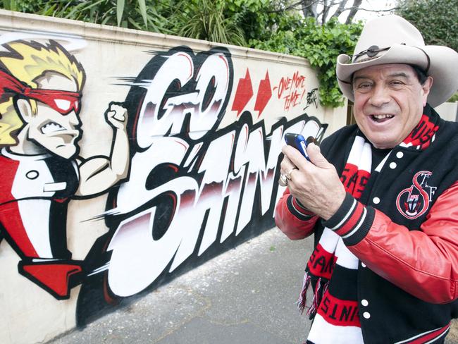 Molly Meldrum is famous for painting his message to his beloved Saints on the fence of his home.