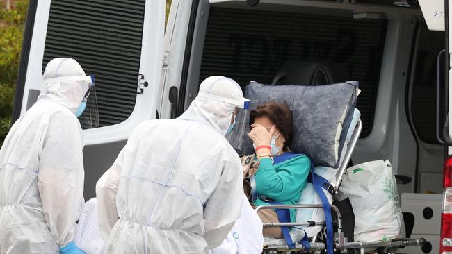 A resident is taken away from an aged care facility. Picture: David Crosling