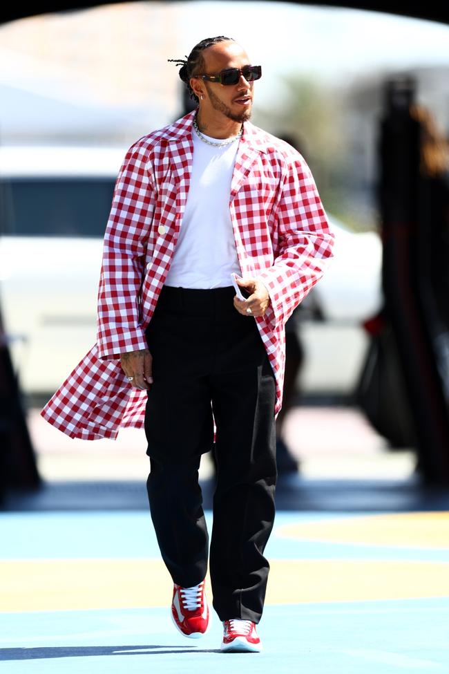 Lewis Hamilton wears a Prada cotton coat, sunglasses and sneakers, with a Calvin Klein T-shirt and Off-White drill pants at the Saudi Arabian Grand Prix.