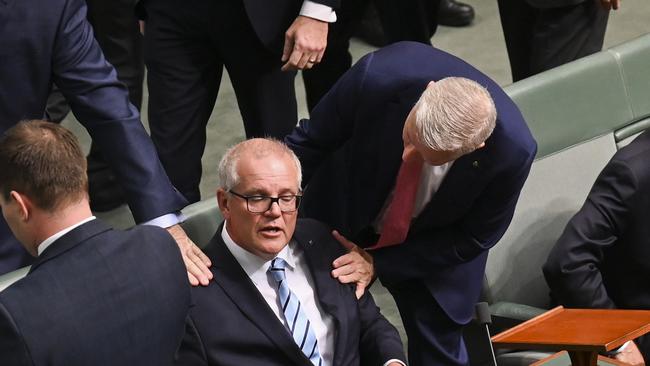 Former Nationals leader Michael McCormack checks in on Scott Morrison during the censure motion. Picture: NCA NewsWire / Martin Ollman