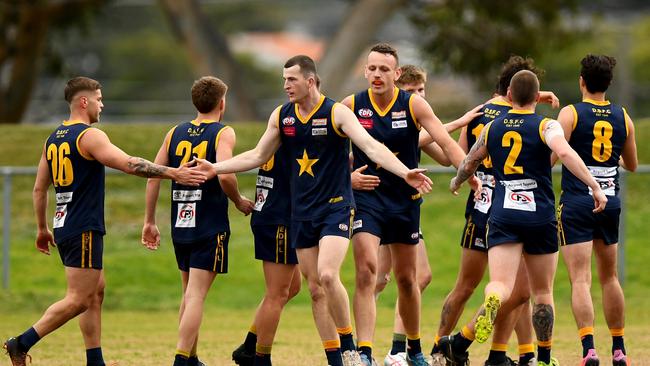 George Romios of Essendon Doutta Stars is congratulated by team mates after kicking a goal during the round 16 Strathmore Community Bank Premier Division match between Essendon Doutta Stars and Maribyrnong Park at Nipper Jordan Oval in Essendon, Victoria on August 12, 2023. (Photo by Josh Chadwick)