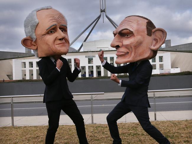 Environmental protesters wearing Malcolm Turnbull and Tony Abbott heads on the lawns of Parliament House in Canberra. Picture: Gary Ramage