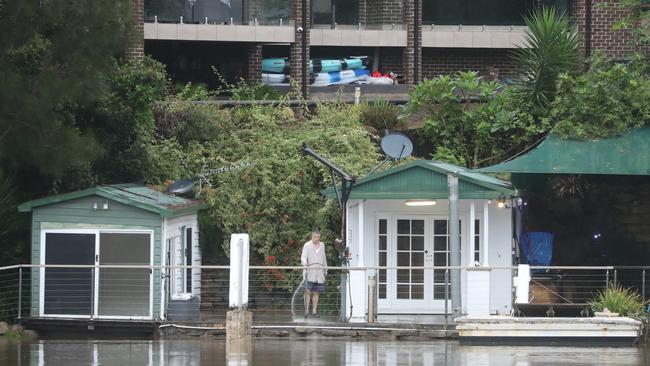 Water approaches waterfront properties in Picnic Point on March 3. Picture: John Grainger