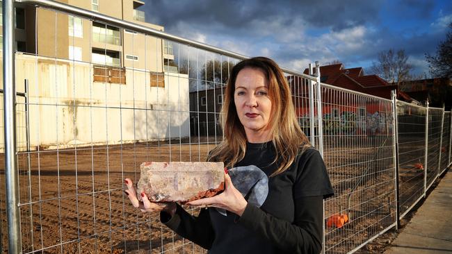 Greyhound regular Julie Marrington with a brick from the pub’s demolition. Picture: Hamish Blair