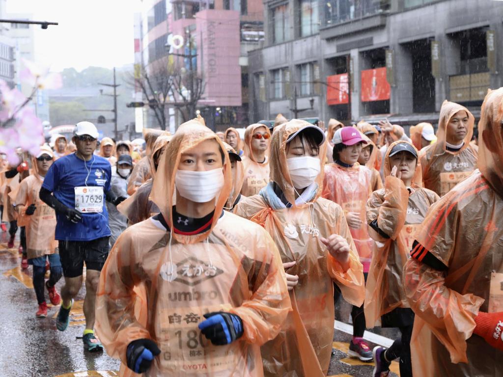 Runners wearing masks compete in a Kumamoto castle marathon in Kumamoto city, western Japan. Picture: Kyodo News via AP