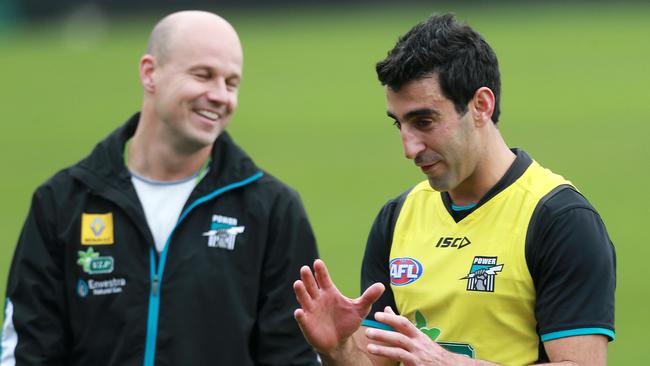 Then Port assistant coach Matthew Nicks and Domenic Cassisi share a laugh.