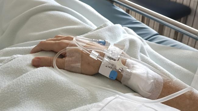 Patient in hospital bed with intravenous route