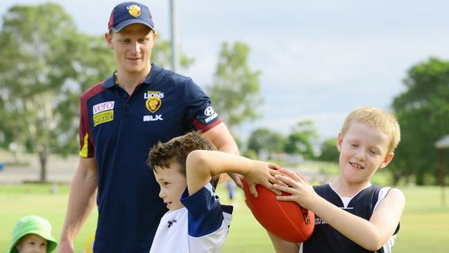 Brisbane Lions AFL players conduct a kids footy clinic at Limestone Park. Lions player Mitch Golby with Jett Preston, 8, of North Booval and Isaac Olver, 8, of One Mile. Photo: David Nielsen / The Queensland Times