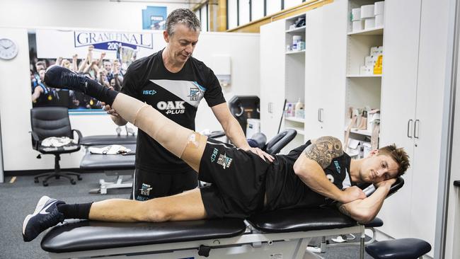 Physio Mike Heynen checks on Hartlett’s range of movement after his surgery. Picture SARAH REED