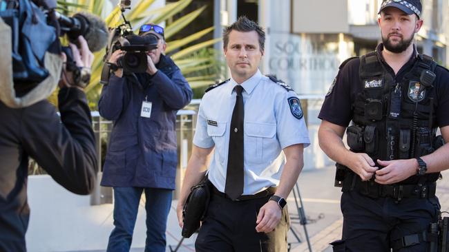 Forensic crash investigator Senior Constable Steven Cornish (left) leaves the Southport Magistrates Court after giving evidence at the coroner's inquest, into the deaths of four people at Dreamworld in October 2016. (AAP Image/Glenn Hunt)