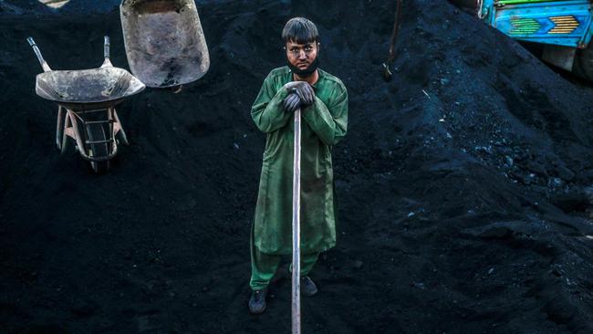 A Hazara worker shovels coal in Bamiyan province. Picture: AFP