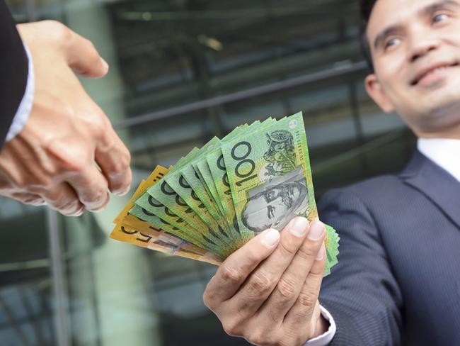 Businessmen passing money, Australia dollar bills, tax refund, generic