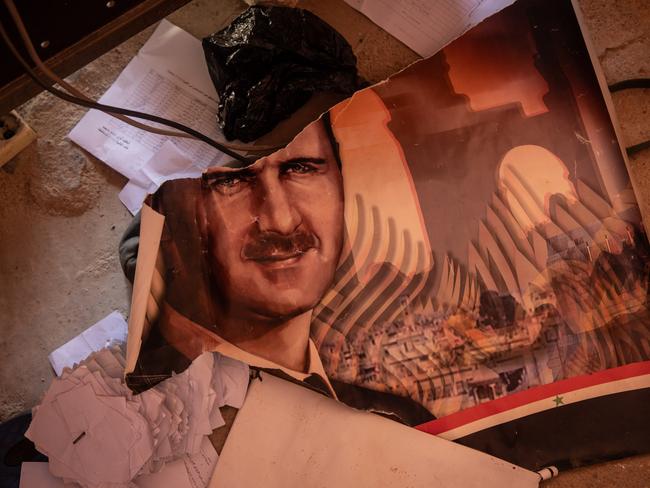 A ripped poster showing the image of Bashar al-Assad is seen on the floor inside one of Syria’s 4th Division bases on December 14, 2024 in Damascus, Syria. Picture: Chris McGrath/Getty Images