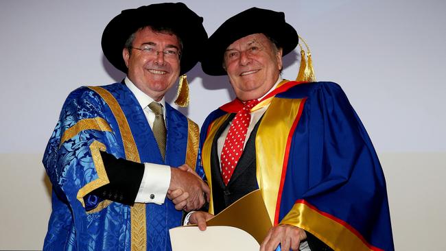 Pomp and ceremony — the then-University of South Australia chancellor Jim McDowell presents an honorary doctorate to Barry Humphries. Picture Calum Robertson
