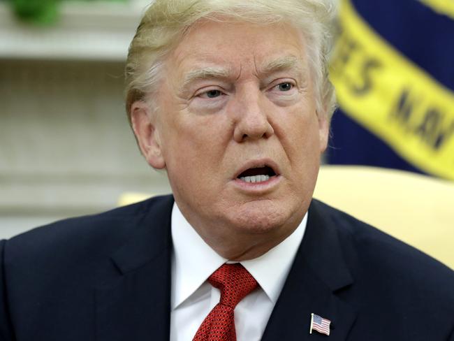 FILE- In this Monday, Oct. 23, 2017, file photo, President Donald Trump meets with Singapore's Prime Minister Lee Hsien Loong in the Oval Office of the White House in Washington. The Department of Justice on Monday is arguing in a New York court that it shouldnâ€™t have to turn over records related to Trumpâ€™s decision to end a program protecting some young immigrants from deportation. (AP Photo/Evan Vucci, File)